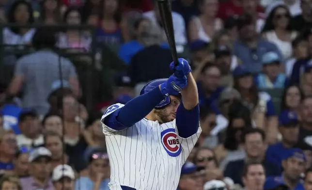 Chicago Cubs' Michael Busch hits a one-run single during the fifth inning of a baseball game against the St. Louis Cardinals in Chicago, Sunday, Aug. 4, 2024. (AP Photo/Nam Y. Huh)