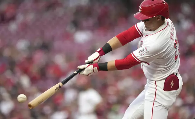 Cincinnati Reds' TJ Friedl hits a single during the third inning of a baseball game against the St. Louis Cardinals, Tuesday, Aug. 13, 2024, in Cincinnati. (AP Photo/Kareem Elgazzar)