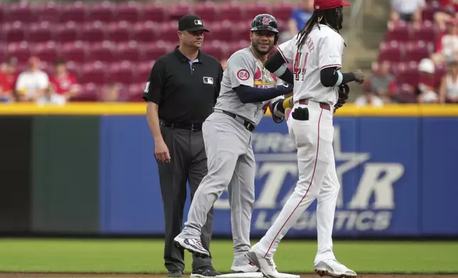 St. Louis Cardinals' Willson Contreras smiles toward the dugout after hitting a double during the first inning of a baseball game against the Cincinnati Reds, Tuesday, Aug. 13, 2024, in Cincinnati. (AP Photo/Kareem Elgazzar)