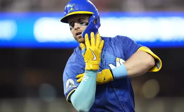 Minnesota Twins' Ryan Jeffers gestures after hitting a single during the third inning of a baseball game against the St. Louis Cardinals, Friday, Aug. 23, 2024, in Minneapolis. (AP Photo/Abbie Parr)