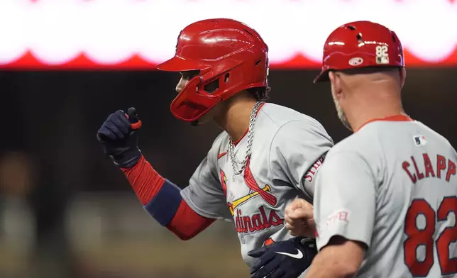 St. Louis Cardinals' Masyn Winn, left, gestures after hitting a single during the fifth inning of a baseball game against the Minnesota Twins, Friday, Aug. 23, 2024, in Minneapolis. (AP Photo/Abbie Parr)