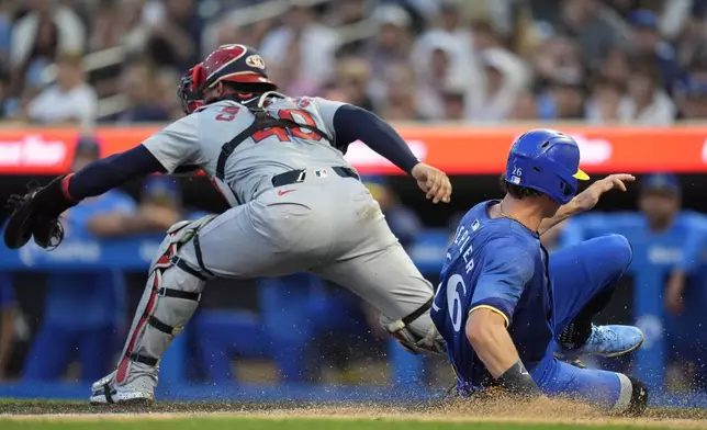 Minnesota Twins' Max Kepler, right, is forced out while attempting to score off a fielder's choice hit into by Twins' Willi Castro during the second inning of a baseball game against the St. Louis Cardinals, Friday, Aug. 23, 2024, in Minneapolis. (AP Photo/Abbie Parr)