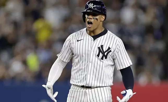 New York Yankees' Juan Soto reacts after hitting a run scoring double during the third inning of a baseball game against the St. Louis Cardinals, Friday, Aug. 30, 2024, in New York. (AP Photo/Adam Hunger)