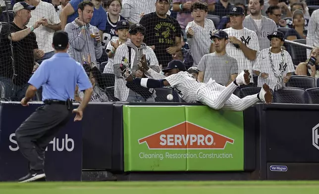 New York Yankees third baseman Jazz Chisholm Jr. can't make a play on a foul ball during the third inning of a baseball game against the St. Louis Cardinals Friday, Aug. 30, 2024, in New York. (AP Photo/Adam Hunger)