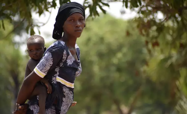 28-year-old Milla Nemoudji, a woman who was divorced by her husband following years of physical abuse, is photographed in a village of Binmar, Chad, Friday, July 19, 2024. (AP Photo/Robert Bociaga)