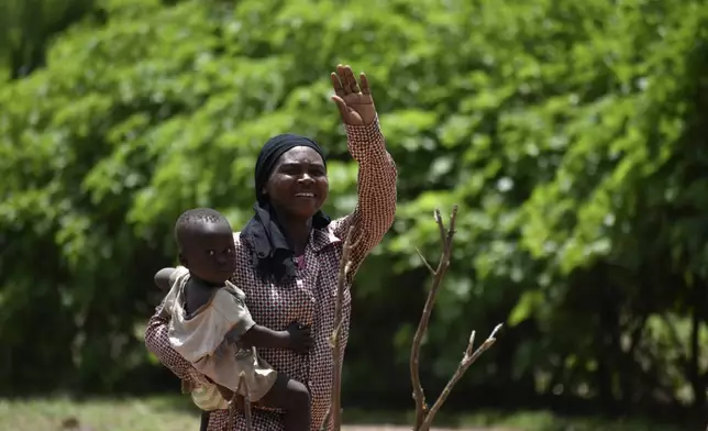 32 year old Marie Depaque, a mother of four children, gestures as she is photographed at the village of Binmar, Chad, Friday, July 19, 2024. (AP Photo/Robert Bociaga)