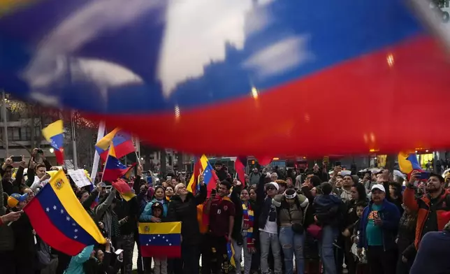 Venezuelans protest the reelection of Venezuelan President Nicolas Maduro one month after the disputed presidential vote which the opposition claims it won by a landslide, in Santiago, Chile, Wednesday, Aug. 28, 2024. (AP Photo/Esteban Felix)