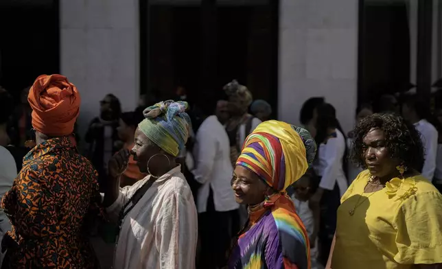 Women line up to attend a forum on Afro women and power with Prince Harry and his wife Meghan in Cali, Colombia, Sunday, Aug. 18, 2024. (AP Photo/Ivan Valencia)