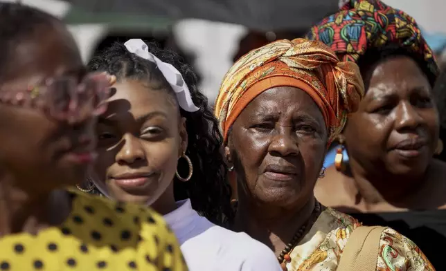 Women line up to attend a forum on Afro women and power with Prince Harry and his wife Meghan in Cali, Colombia, Sunday, Aug. 18, 2024. (AP Photo/Ivan Valencia)