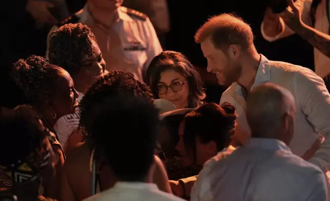 Prince Harry greets people during a forum on Afro women and power in Cali, Colombia, Sunday, Aug. 18, 2024. (AP Photo/Ivan Valencia)