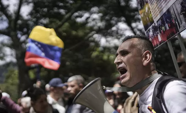 Demonstrators protest Venezuela's contested presidential election results outside Venezuela's consulate in Bogota, Colombia, Thursday, Aug. 1, 2024. (AP Photo/Ivan Valencia)