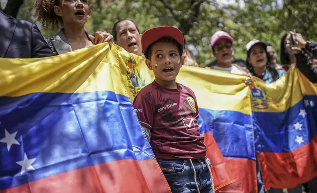 Demonstrators hold a Venezuelan flag outside that nation's consulate to protest the contested presidential election results in Bogota, Colombia, Thursday, Aug. 1, 2024. (AP Photo/Ivan Valencia)