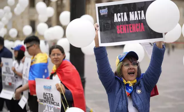 Gladis Echeto, 58, protests the reelection of Venezuelan President Nicolas Maduro one month after the disputed presidential vote which the opposition claims it won by a landslide in Bogota, Colombia, Wednesday, Aug. 28, 2024. (AP Photo/Fernando Vergara)