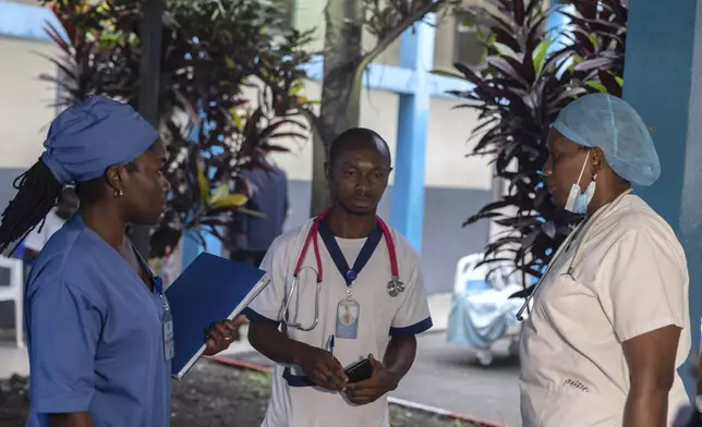 Medical staff talk to each other at the general hospital in Goma, Democratic Republic Of Congo, Wednesday, Aug. 14, 2024 after the World Health Organization declared the mpox outbreaks in Congo and elsewhere in Africa a global emergency. (AP Photo/Moses Sawasawa)