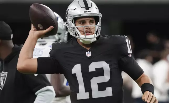 Las Vegas Raiders quarterback Aidan O'Connell (12) warms up before an NFL preseason football game against the Dallas Cowboys, Saturday, Aug. 17, 2024, in Las Vegas. (AP Photo/Rick Scuteri)