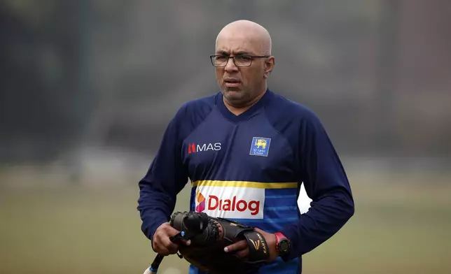 FILE - Sri Lanka's head coach Chandika Hathurusingha walks on the field during a training session ahead of the Tri-Nation one-day international cricket series in Dhaka, Bangladesh, Sunday, Jan. 14, 2018. Bangladesh head coach Chandika Hathurusingha is still interested in completing his contract with the men’s national cricket team to 2025 despite the recent political turmoil in the country. Bangladesh starts its first test against Pakistan in Rawalpindi on Wednesday, Aug. 21, 2024. (AP Photo/A.M. Ahad, file)