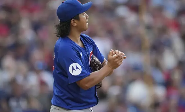 Chicago Cubs starting pitcher Shota Imanaga rubs a baseball between batters in the third inning of a baseball game against the Cleveland Guardians, Monday, Aug. 12, 2024, in Cleveland. (AP Photo/Sue Ogrocki)