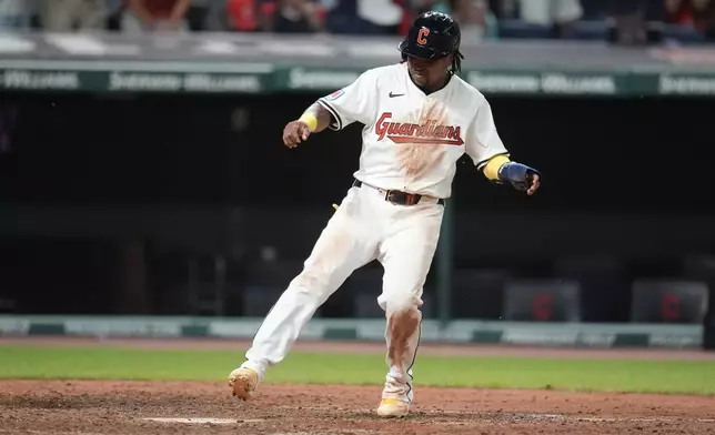 Cleveland Guardians' Jose Ramirez scores on a single hit by Josh Naylor in the eighth inning of a baseball game against the Chicago Cubs, Monday, Aug. 12, 2024, in Cleveland. (AP Photo/Sue Ogrocki)