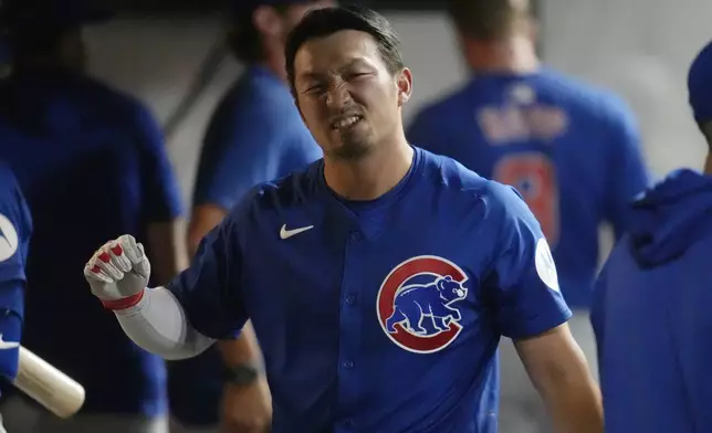 Chicago Cubs' Seiya Suzuki reacts in the dugout after hitting a sacrifice fly in the eighth inning of a baseball game against the Cleveland Guardians, Monday, Aug. 12, 2024, in Cleveland. (AP Photo/Sue Ogrocki)