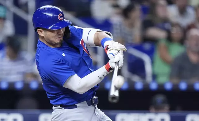 Chicago Cubs' Seiya Suzuki, of Japan, pops out during the fifth inning of a baseball game against the Miami Marlins, Friday, Aug. 23, 2024, in Miami. (AP Photo/Wilfredo Lee)