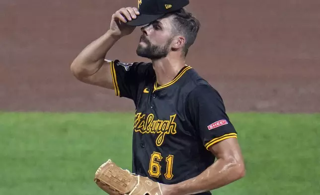 Pittsburgh Pirates relief pitcher Ben Heller reacts on the mound after hitting Chicago Cubs' Nico Hoerner during the fifth inning of a baseball game in Pittsburgh, Tuesday, Aug. 27, 2024. (AP Photo/Gene J. Puskar)