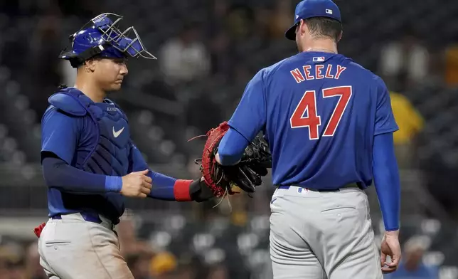 Chicago Cubs relief pitcher Jack Neely, right, celebrates with catcher Miguel Amaya, left, after getting the final out of a baseball game against the Pittsburgh Pirates, Monday, Aug. 26, 2024, in Pittsburgh. (AP Photo/Matt Freed)