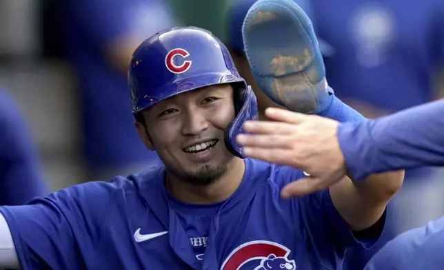 Chicago Cubs' Seiya Suzuki celebrates after scoring during the third inning of a baseball game against the Pittsburgh Pirates, Monday, Aug. 26, 2024, in Pittsburgh. (AP Photo/Matt Freed)