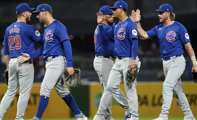 Chicago Cubs teammates celebrate their win over the Pittsburgh Pirates in a baseball game, Monday, Aug. 26, 2024, in Pittsburgh. (AP Photo/Matt Freed)