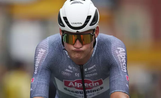 Netherlands' Mathieu van der Poel reacts after crossing the finish line of the twenty-first stage of the Tour de France cycling race, an individual time trial over 33.7 kilometers (20.9 miles) with start in Monaco and finish in Nice, France, Sunday, July 21, 2024. (AP Photo/Daniel Cole)