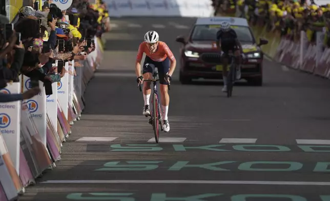 Stage winner Demi Vollering of The Netherlands strains as she sprints to the finish line coming four second short of taking the Tour de France Women's overall win in the eighth stage of the Tour de France Women cycling race with start in Le Grand-Bornand and finish in Alpe d'Huez, France, Sunday, Aug. 18, 2024. (AP Photo/Peter Dejong)