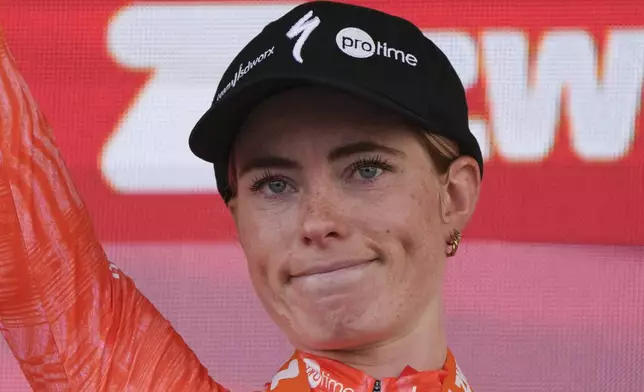 Stage winner Demi Vollering of The Netherlands reacts on the podium after the eighth stage of the Tour de France Women cycling race with start in Le Grand-Bornand and finish in Alpe d'Huez, France, Sunday, Aug. 18, 2024. (AP Photo/Peter Dejong)