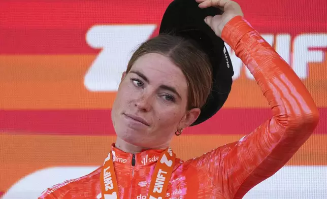 Stage winner Demi Vollering of The Netherlands reacts on the podium after the eighth stage of the Tour de France Women cycling race with start in Le Grand-Bornand and finish in Alpe d'Huez, France, Sunday, Aug. 18, 2024. (AP Photo/Peter Dejong)