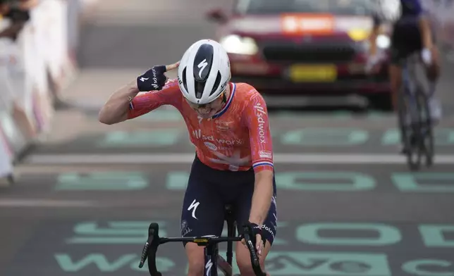 Demi Vollering of The Netherlands crosses the finish line to win the eighth stage of the Tour de France Women cycling race with start in Le Grand-Bornand and finish in Alpe d'Huez, France, Sunday, Aug. 18, 2024. (AP Photo/Peter Dejong)