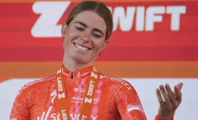 Stage winner Demi Vollering of The Netherlands reacts on the podium after the eighth stage of the Tour de France Women cycling race with start in Le Grand-Bornand and finish in Alpe d'Huez, France, Sunday, Aug. 18, 2024. (AP Photo/Peter Dejong)