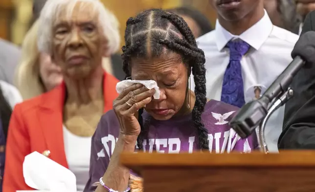 Donna Massey, Sonya Massey's mother, wipes tears from her face as she listens to attorney Ben Crump speak during a press conference over the shooting death of Sonya, who was killed by Illinois sheriff's deputy Sean Grayson, at New Mount Pilgrim Church in the Garfield Park neighborhood in Chicago, Tuesday, July 30, 2024. (Tyler Pasciak LaRiviere/Chicago Sun-Times via AP)