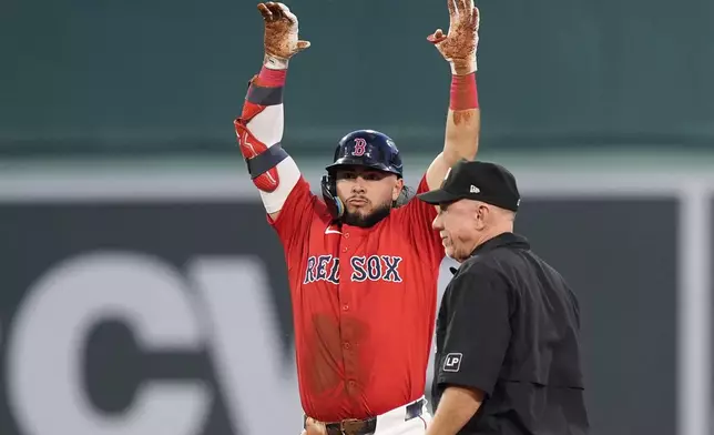 Boston Red Sox's Wilyer Abreu, left, celebrates after his RBI double during the first inning of a baseball game against the Arizona Diamondbacks, Friday, Aug. 23, 2024, in Boston. (AP Photo/Michael Dwyer)