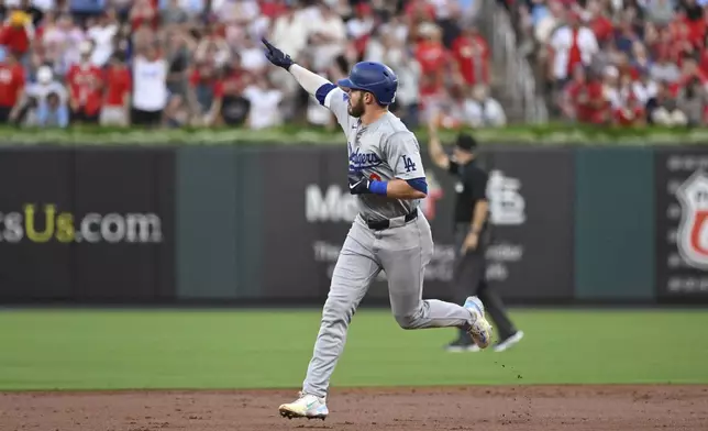 Los Angeles Dodgers' Gavin Lux gestures to teammates after hitting a home run during the first inning of a baseball game against the St. Louis Cardinals, Friday, Aug. 16, 2024, in St. Louis. (AP Photo/Jeff Le)