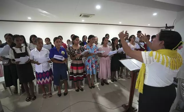 Timorese women sing during mass at a church In Dili, East Timor, Sunday, Aug. 11, 2024. (AP Photo/Achmad Ibrahim)