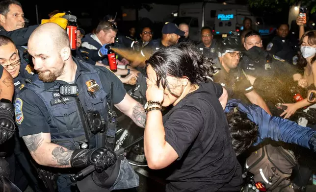 FILE - Officers of the Metropolitan Police Department pepper spray demonstrators at George Washington University in Washington, May 8, 2024. More than 3,200 people were arrested on campuses this spring during a wave of pro-Palestinian tent encampments protesting the war in Gaza. (Sage Russell/GW Hatchet via AP, File)