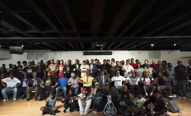 Attendees pose for photos after a Black Man Lab meeting to discuss the candidacy of Vice President Kamala Harris, Monday, July 22, 2024, in Atlanta. (AP Photo/Stephanie Scarbrough)