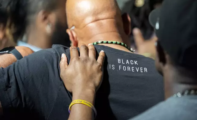 Attendees gather and pray during a Black Man Lab meeting to discuss the candidacy of Vice President Kamala Harris, Monday, July 22, 2024, in Atlanta. (AP Photo/Stephanie Scarbrough)