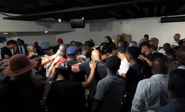 Attendees gather and pray during a Black Man Lab meeting to discuss the candidacy of Vice President Kamala Harris, Monday, July 22, 2024, in Atlanta. (AP Photo/Stephanie Scarbrough)