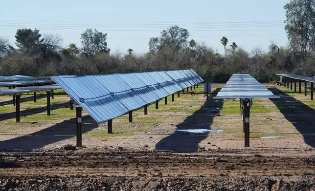 FILE - Rows of solar panels sit at Orsted's Eleven Mile Solar Center lithium-ion battery storage energy facility, Feb. 29, 2024, in Coolidge, Ariz. (AP Photo/Ross D. Franklin, File)