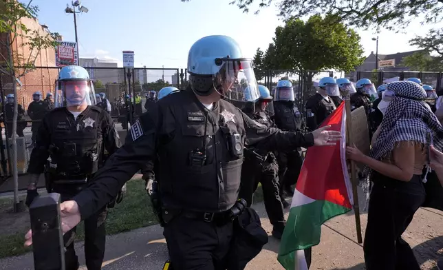 Police direct protesters at the United Center after a march at the Democratic National Convention Monday, Aug. 19, 2024, in Chicago. (AP Photo/Alex Brandon)