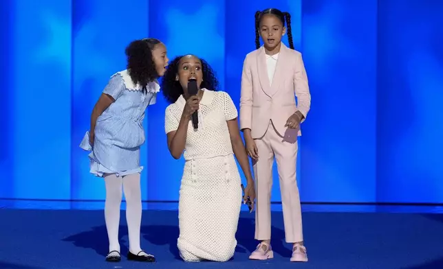 Kerry Washington, center, with grand-nieces of Vice President Kamala Harris Amara Ajagu, right, and Leela Ajagu, speak during the Democratic National Convention Thursday, Aug. 22, 2024, in Chicago. (AP Photo/J. Scott Applewhite)