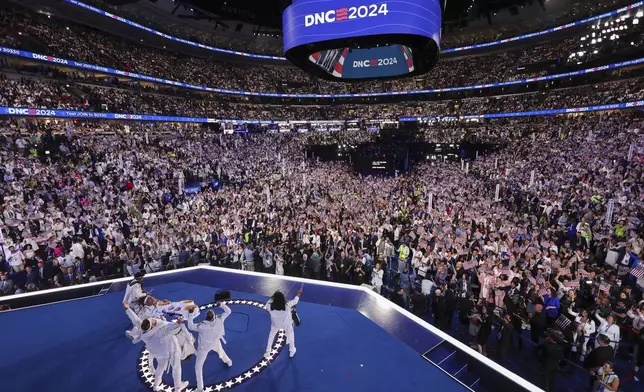 The Pack Drum Line, the official drum line of the Chicago Sky and the Chicago Bulls, perform during the final day of the Democratic National Convention in Chicago, Thursday, Aug. 21, 2024. (Mike Segar/Pool via AP)