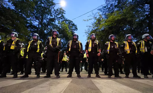 Police watch as protesters march during a demonstration near the Democratic National Convention Thursday, Aug. 22, 2024, in Chicago. (AP Photo/Alex Brandon)