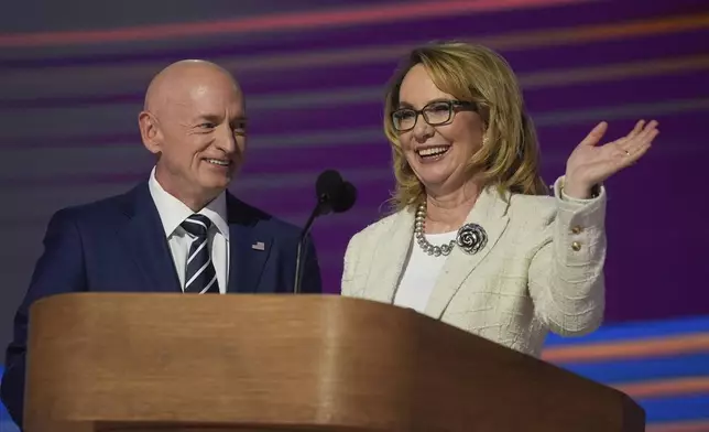 Former Rep. Gabrielle Giffords, of Arizona, right, and her husband Sen. Mark Kelly, D-Ariz., appear during the Democratic National Convention Thursday, Aug. 22, 2024, in Chicago. (AP Photo/Erin Hooley)