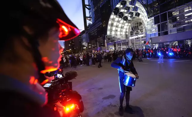 A police officer watches a protest near the Israeli Consulate during the Democratic National Convention Tuesday, Aug. 20, 2024, in Chicago. (AP Photo/Alex Brandon)