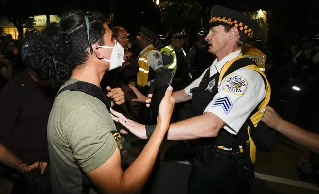 Police move protesters during a demonstration near the Democratic National Convention Thursday, Aug. 22, 2024, in Chicago. (AP Photo/Julio Cortez)